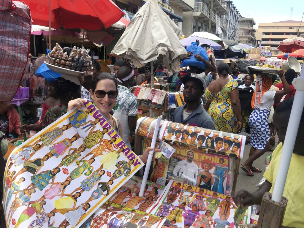 Posters for seamstresses, of outfits to sew, being sold at Makola Market Accra
