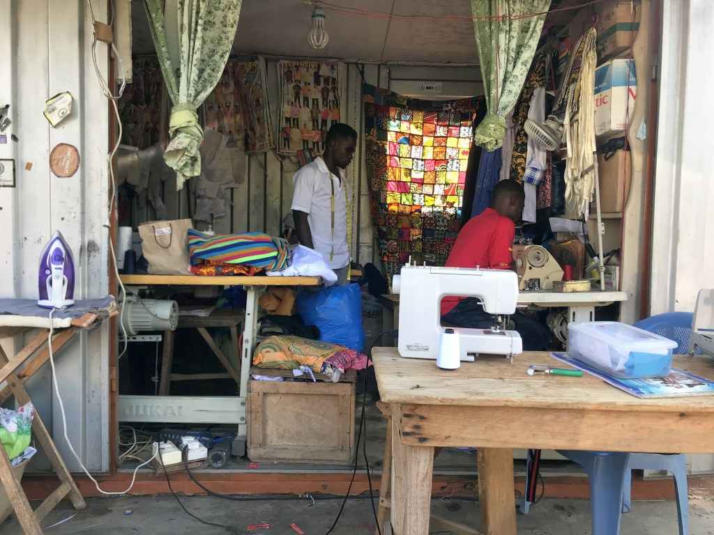 Tailors sewing from a container in Accra Ghana 
