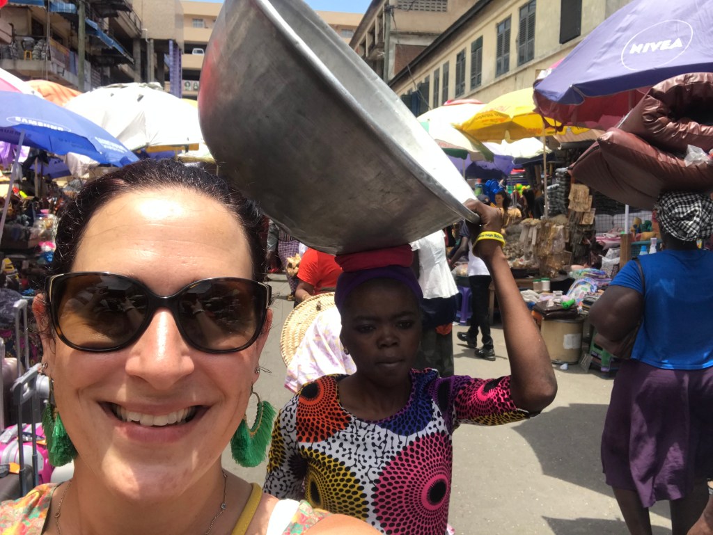 Kayayo girl carrying a silver bowl at Makola Market