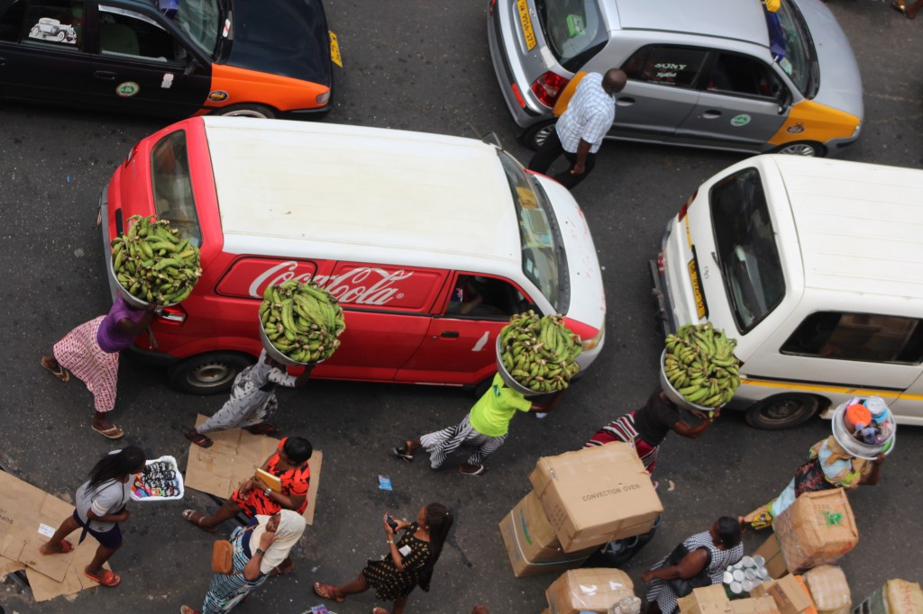 Kayayo girls at Makola Market carrying silver bowls of plantain