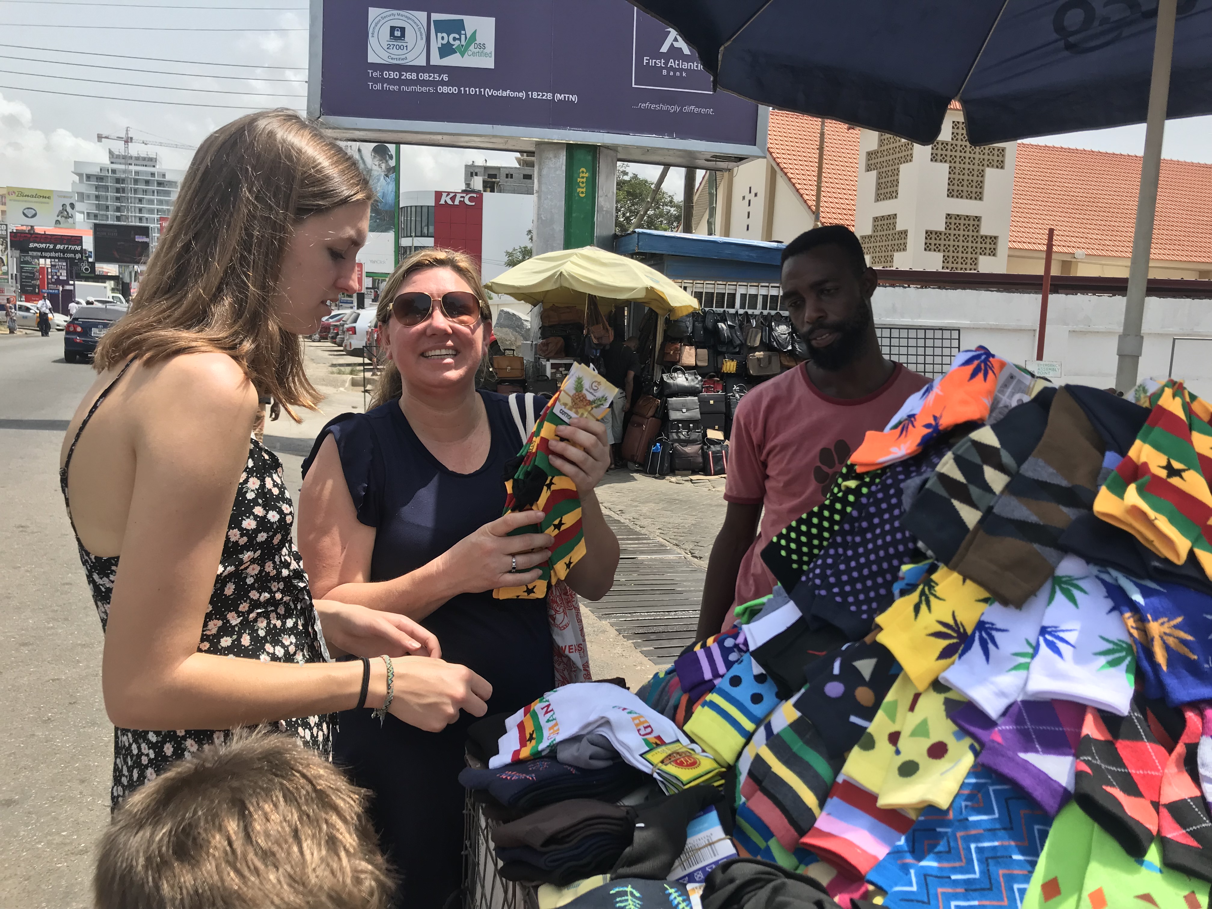 Buying Ghanaian flag socks on Accra's Oxford Street