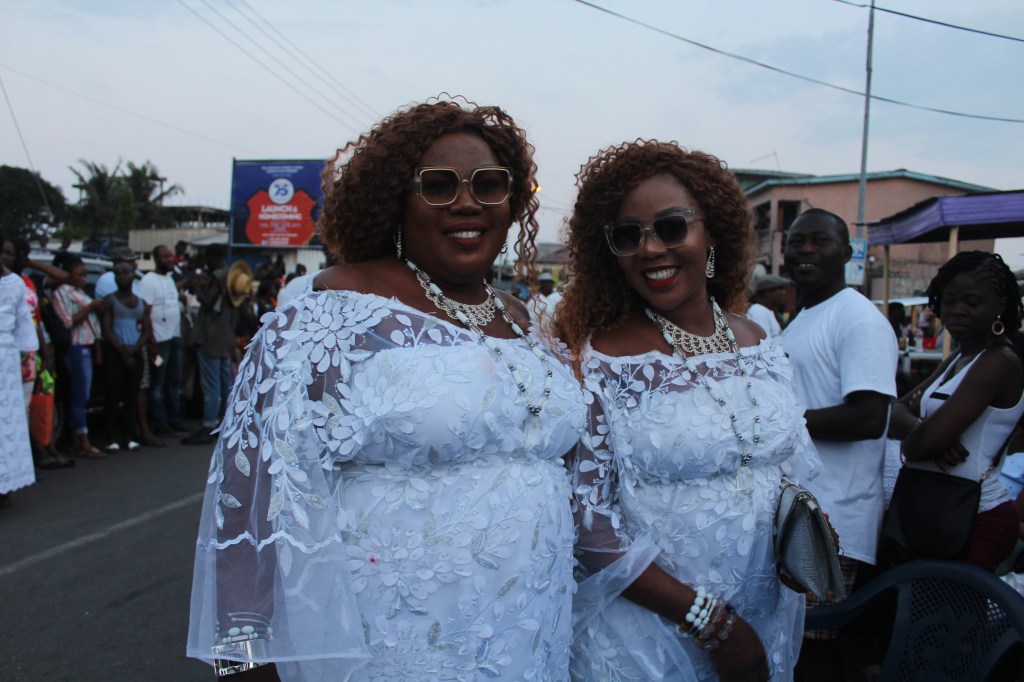 Twin ladies wearing white lace dresses at the Jamestown Accra Ga Mashie Twin Festival
