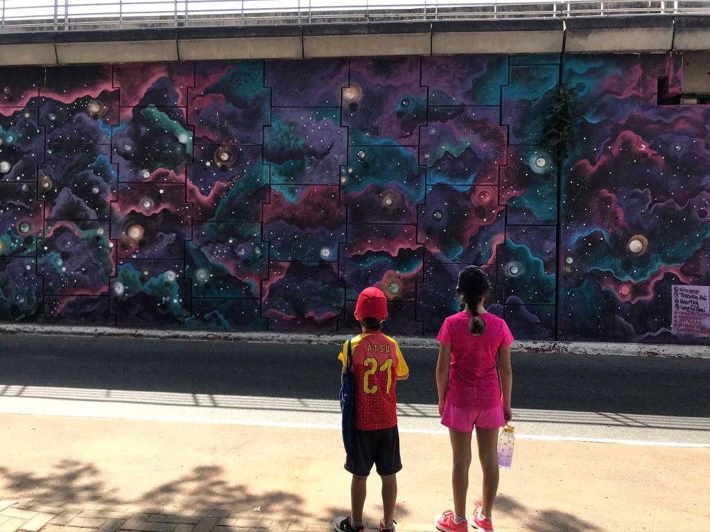 Ghana street art - Murals at the Ako Adjei interchange Accra Ghana depicting an outer space scene. 