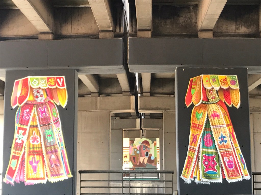 Ghana street art - Murals at the Ako Adjei interchange Accra Ghana of Beninese voodoo ceremonial capes
