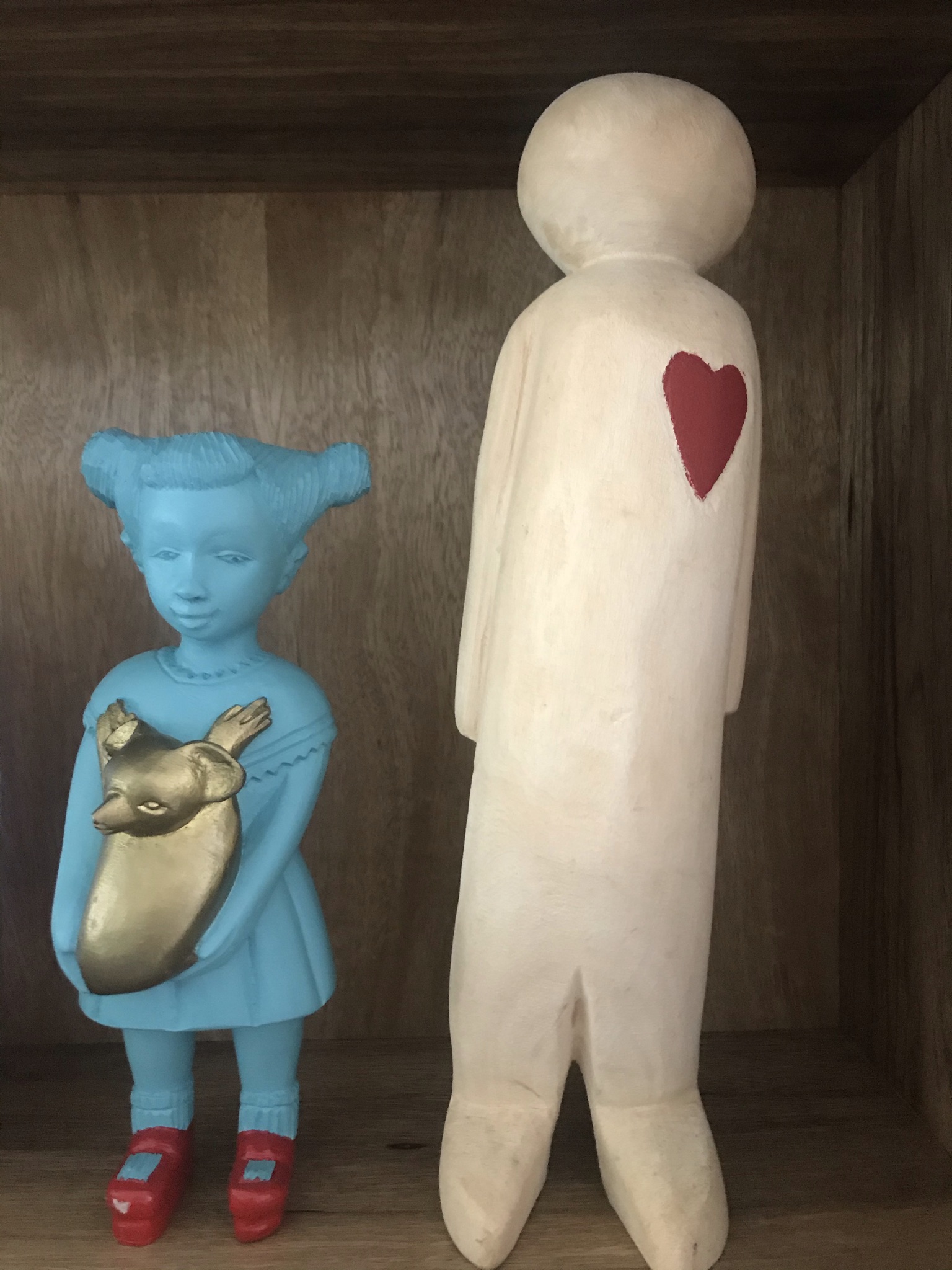 Koala Kate Doll made by Manoushka Kraal stands next to a large wooden figure of a man