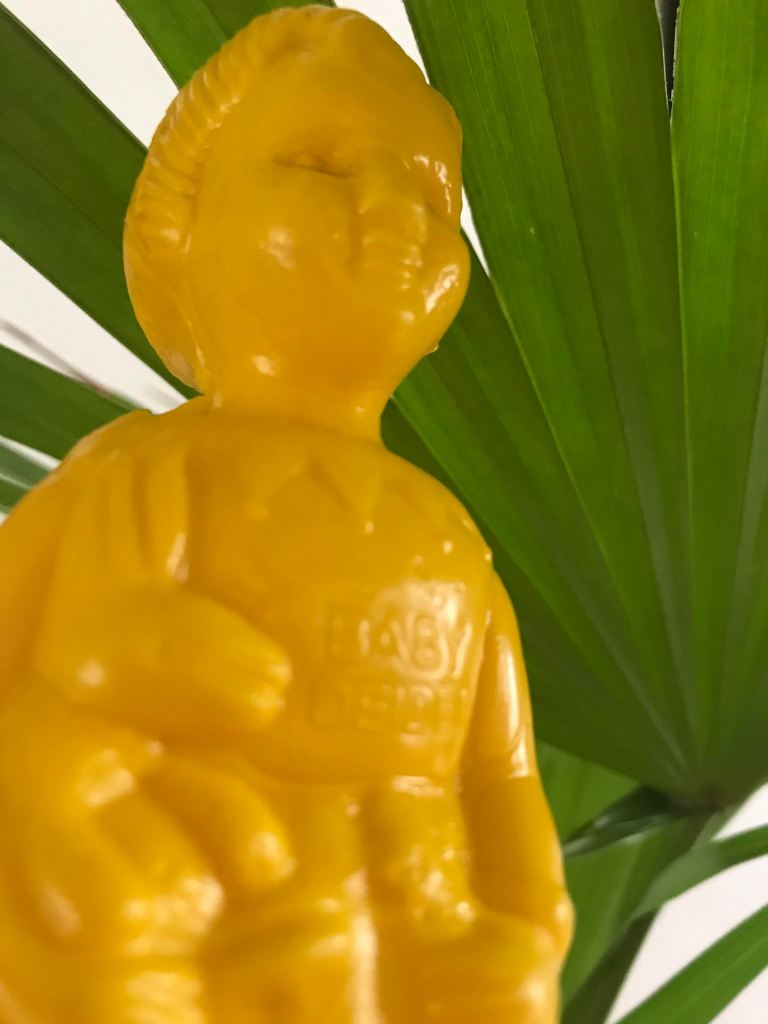 The name Baby Dei Dei can be seen on the belly of a yellow Clonette Doll