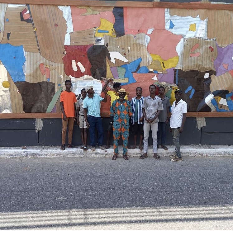 Ghanaian Artist Tei Huagie and his sons work on the street art 'National Inspiration' in Accra Ghana