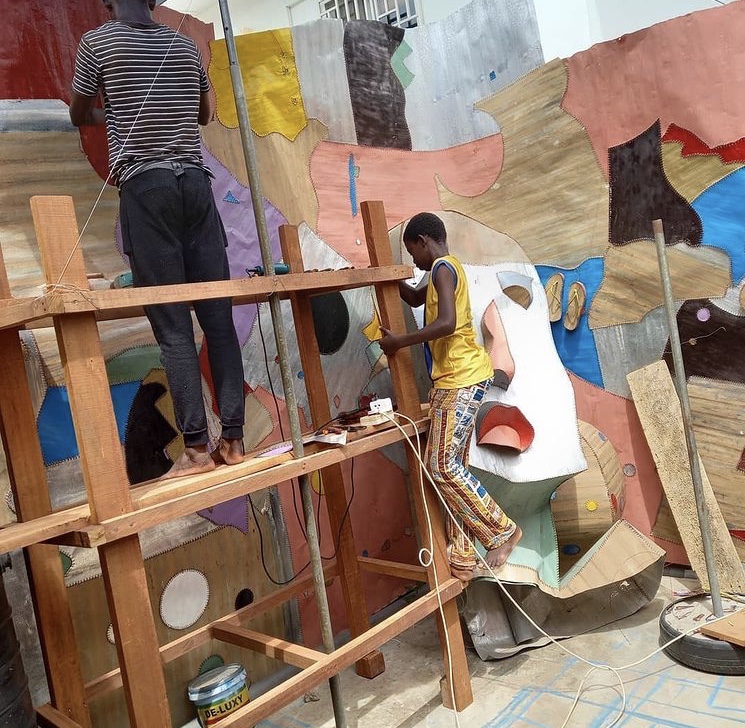 Ghanaian Artist Tei Huagie and his sons work on the street art 'National Inspiration' in Accra Ghana